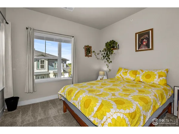 a bed sitting in a bedroom next to a window