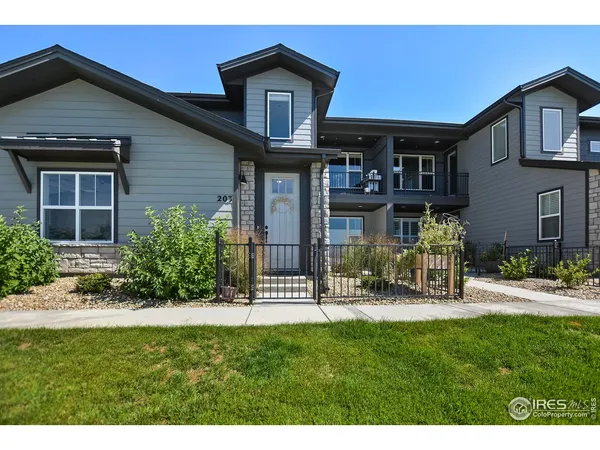 a front view of a house with porch and garden