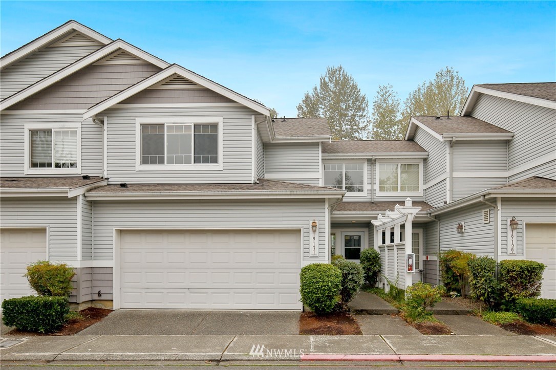 19131 110th Place Southeast Renton, WA 98055 - Photo 1 of 25 a front view of a house with a yard and garage