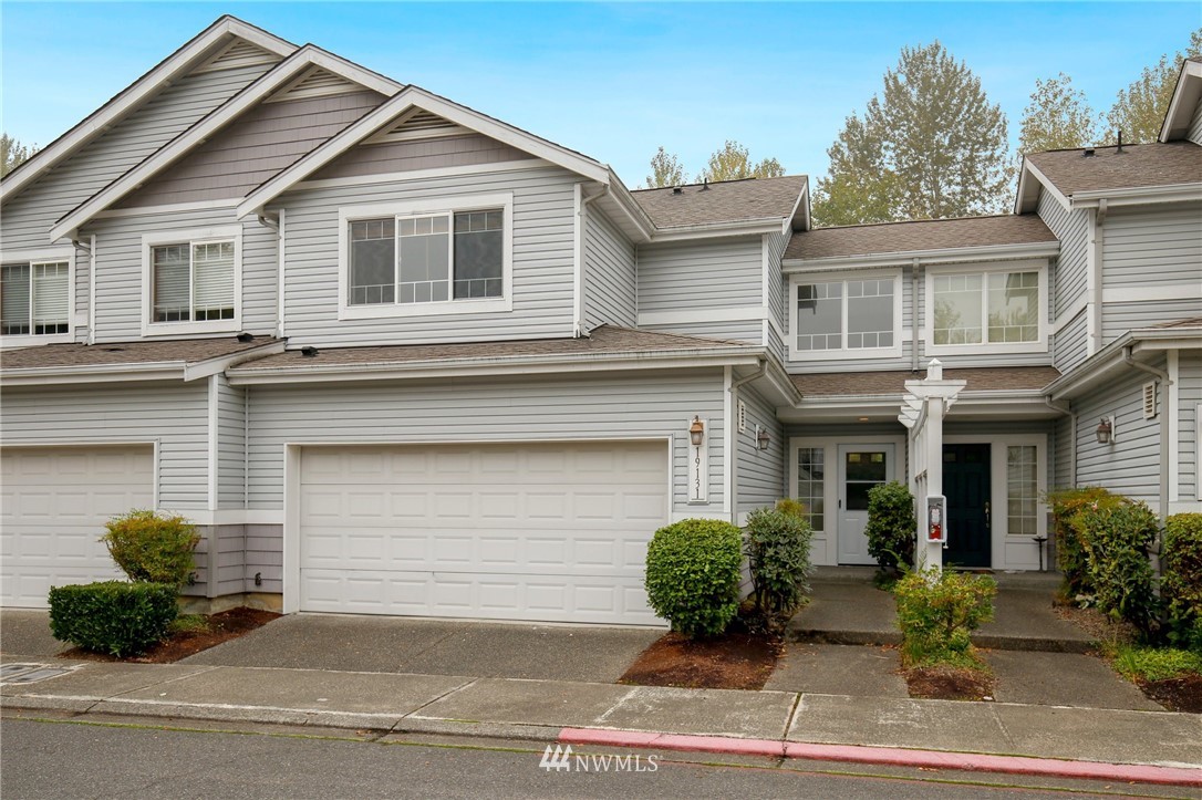 19131 110th Place Southeast Renton, WA 98055 - Photo 24 of 25 a front view of a house with a yard and potted plants