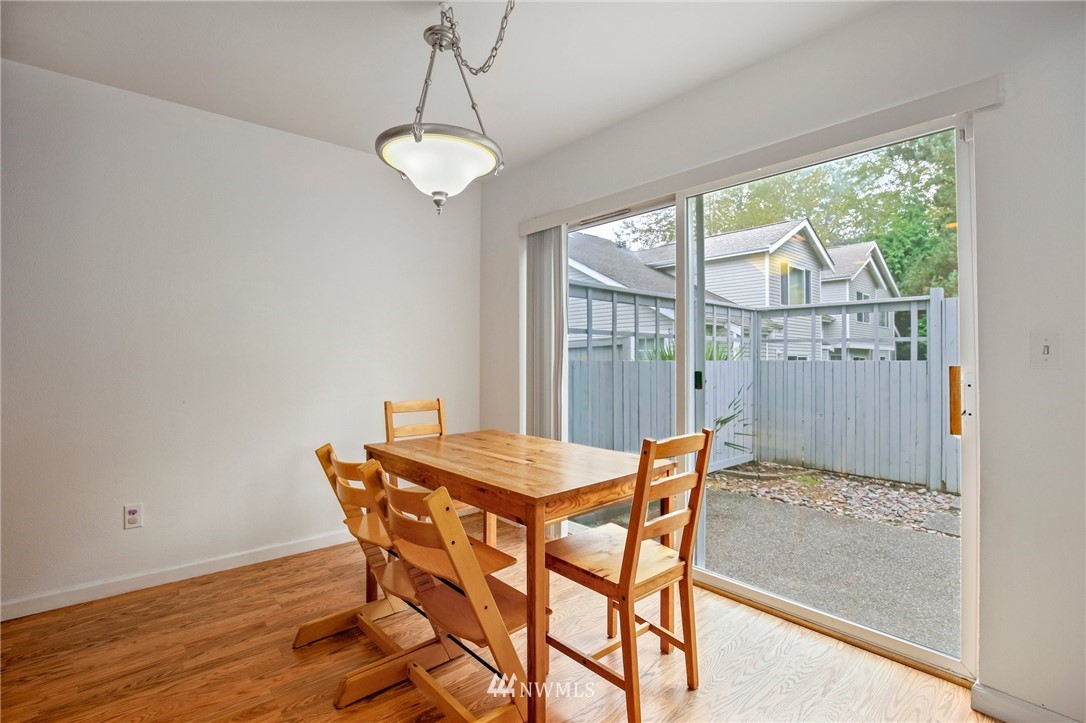 19131 110th Place Southeast Renton, WA 98055 - Photo 9 of 25 a dining room with furniture a chandelier and wooden floor