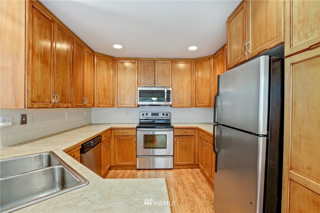 19131 110th Place Southeast Renton, WA 98055 - Photo 10 of 25 a kitchen with a refrigerator sink and microwave