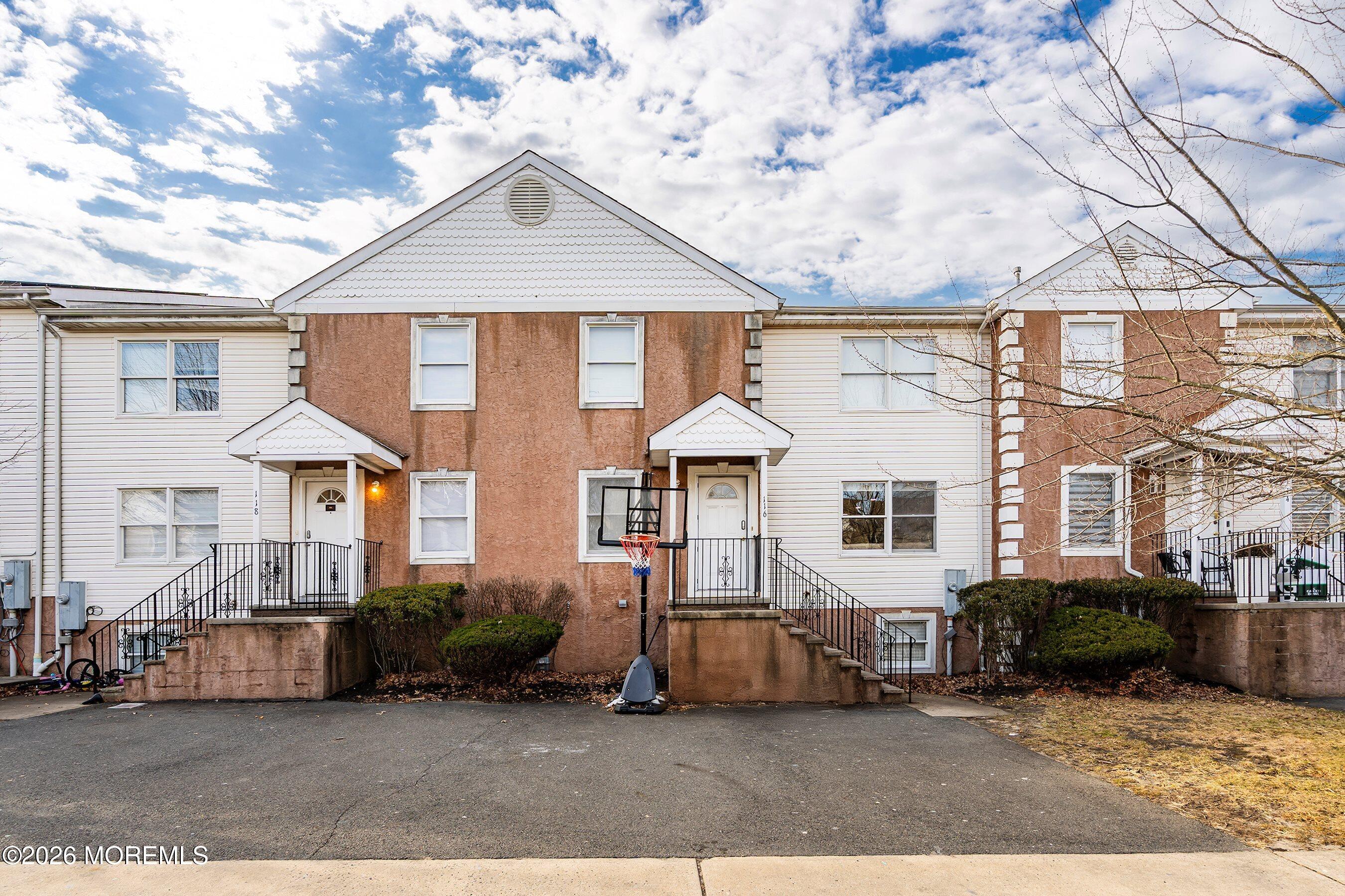 a view of a big house with a large windows and a yard
