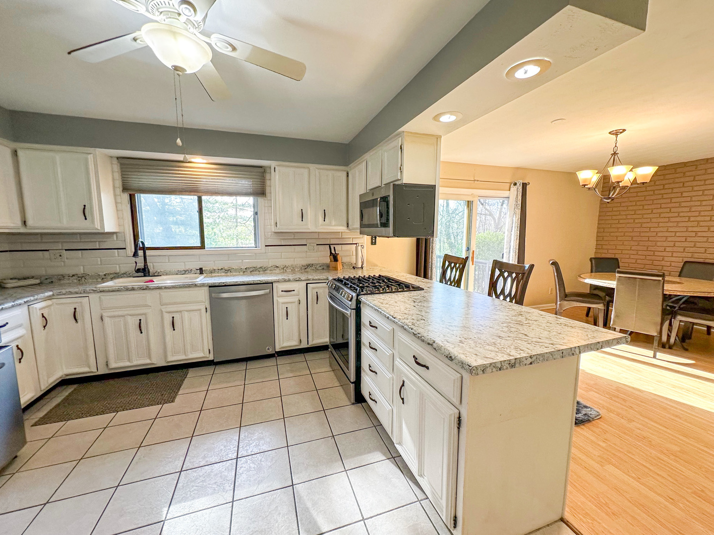 6315 North Post Oak Road Peoria, IL 61615 - Photo 7 of 31 a kitchen with a sink window and cabinets