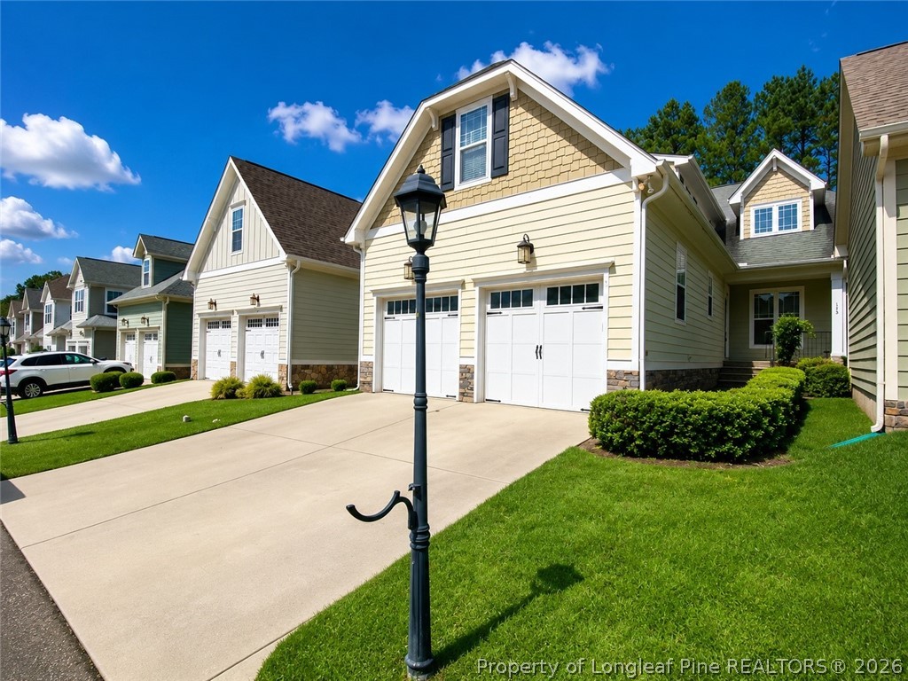 175 Pine Hawk Drive Spring Lake, NC 28390 - Photo 1 of 43 a front view of a house with a yard and garage