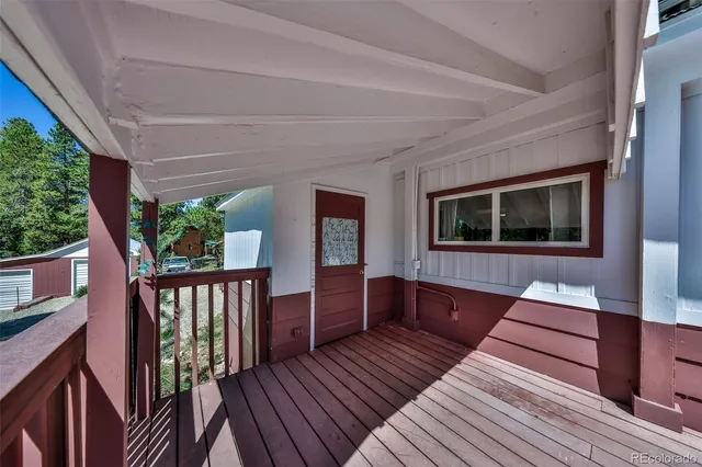 a living room with furniture fireplace and a large window