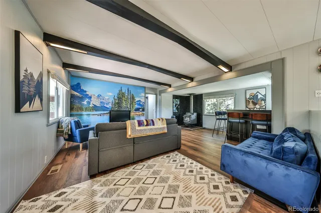 a living room with furniture a window and chairs