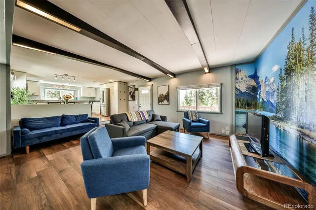 a kitchen with a table chairs refrigerator and cabinets