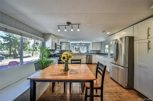 a bathroom with a toilet sink a shower and a mirror