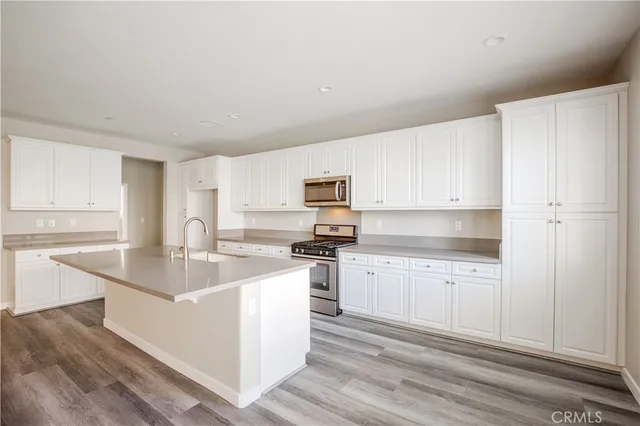 a kitchen with a sink stove and cabinets