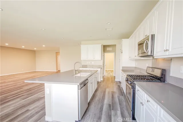 a view of kitchen stove microwave and cabinets