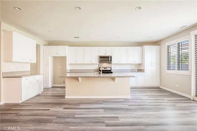 a view of kitchen with wooden floor and windows