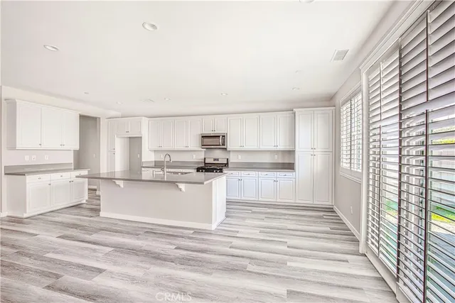 a spacious bathroom with a double vanity sink a mirror and a bathtub