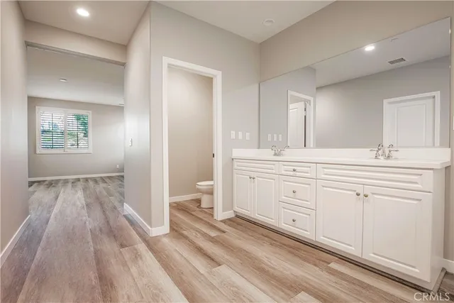 a bathroom with a sink toilet and a mirror