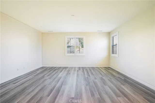 a view of a room with wooden floor
