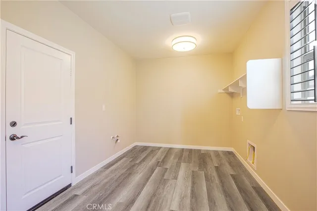 an aerial view of residential houses with outdoor space and parking