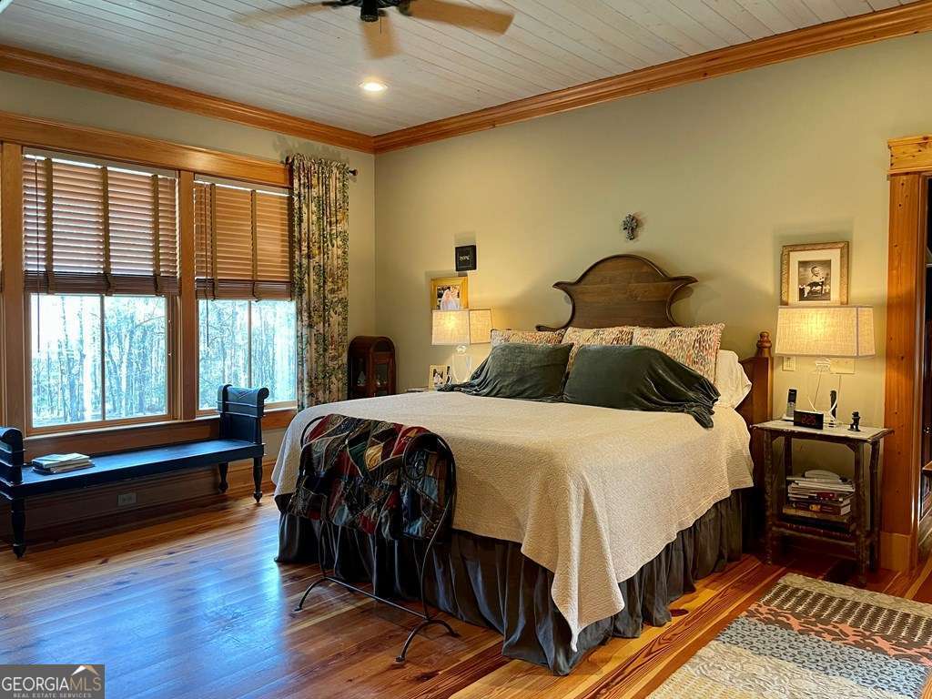 2106 Adams Street Vidalia, GA 30474 - Photo 13 of 47 a bedroom with a bed and wooden floor