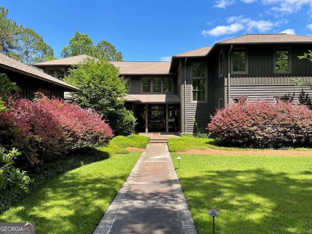 2106 Adams Street Vidalia, GA 30474 - Photo 2 of 47 a front view of a house with garden