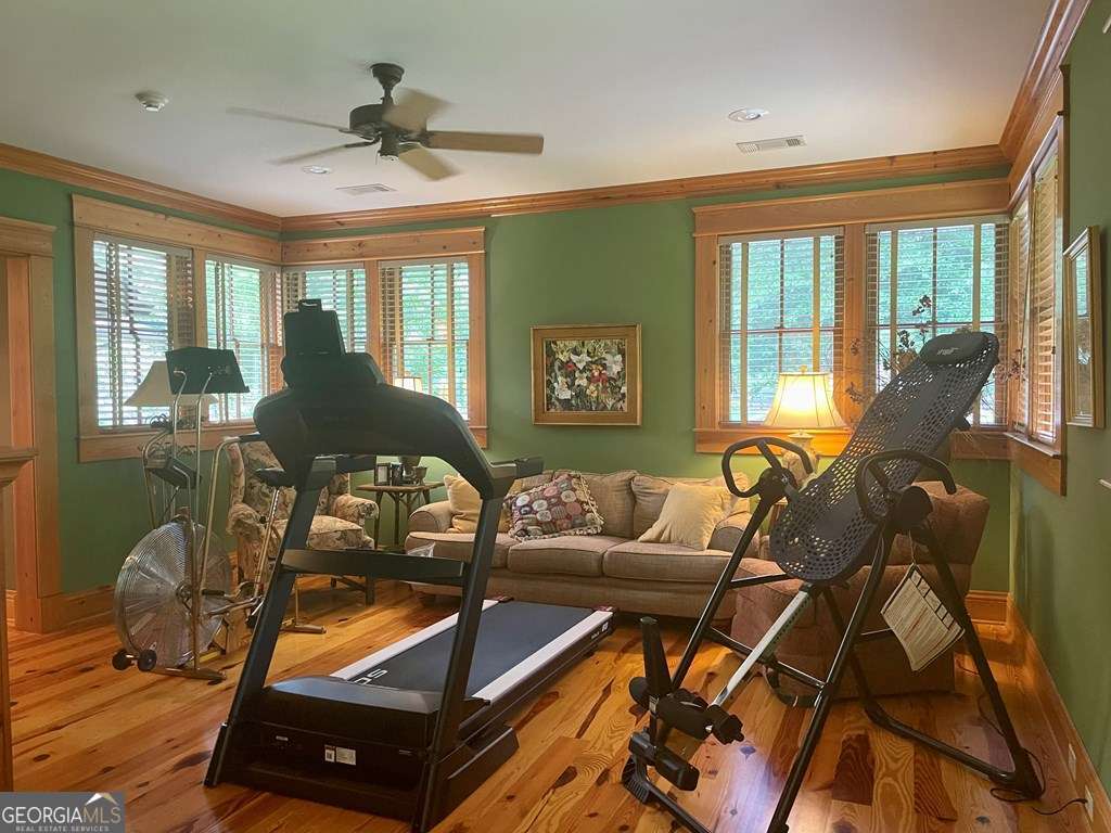 2106 Adams Street Vidalia, GA 30474 - Photo 33 of 47 a living room with furniture gym equipment and a large window