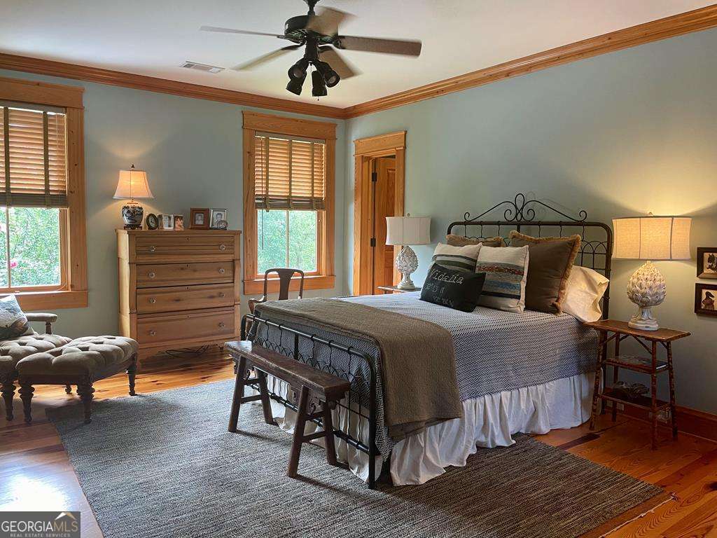 2106 Adams Street Vidalia, GA 30474 - Photo 36 of 47 a bedroom with a bed and wooden floor