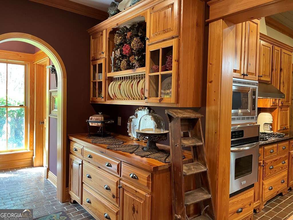 2106 Adams Street Vidalia, GA 30474 - Photo 9 of 47 a kitchen with stainless steel appliances granite countertop a stove and a sink