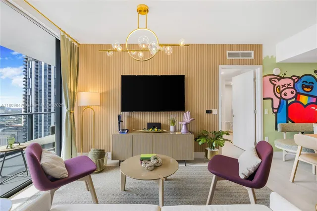 a living room with furniture and a flat screen tv
