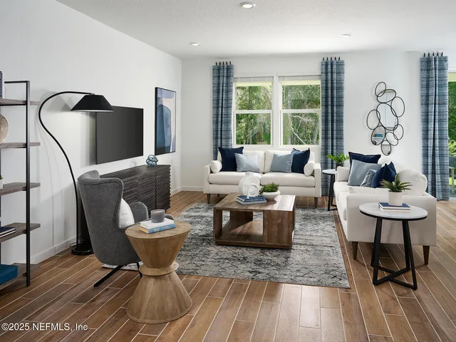 a living room with furniture a rug and a large window