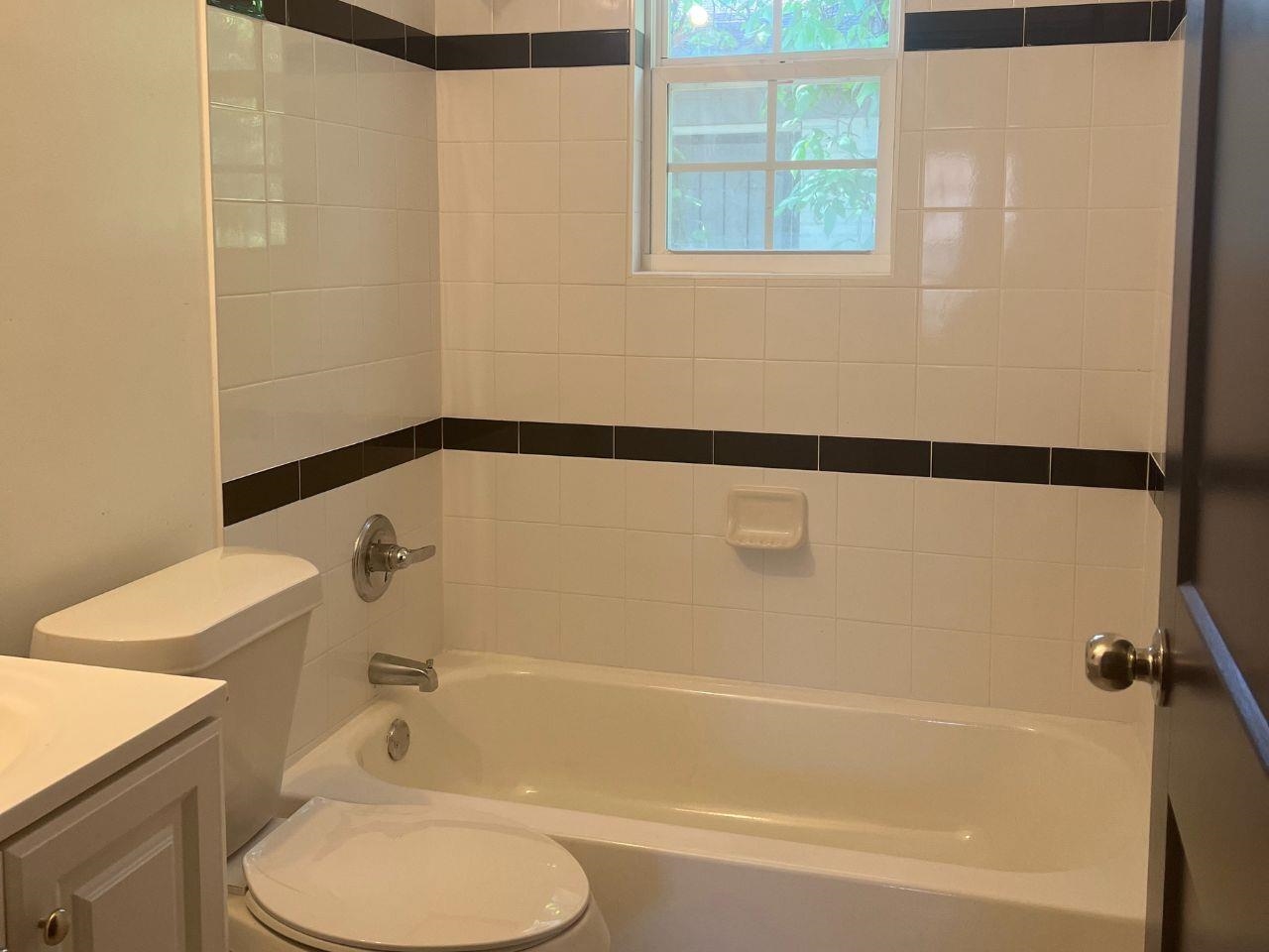 2109 Perry Road Memphis, TN 38106 - Photo 3 of 6 a bathroom with a sink and a bathtub