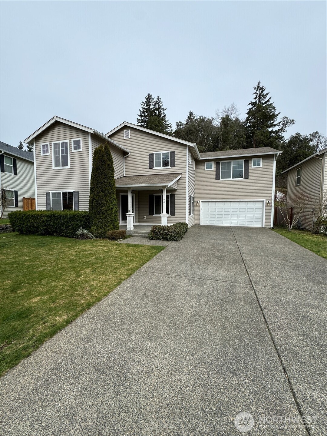 1190 Swan Loop DuPont, WA 98327 - Photo 1 of 24 a front view of a house with a yard and garage