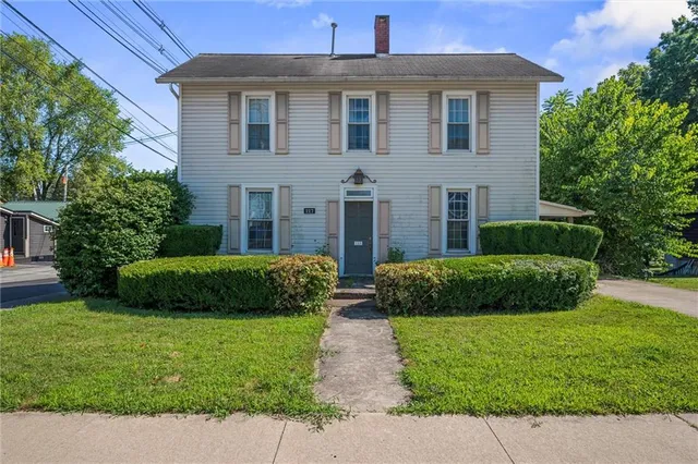 a front view of a house with a garden