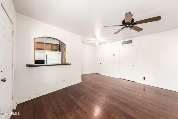 a view of a room with wooden floor and white walls