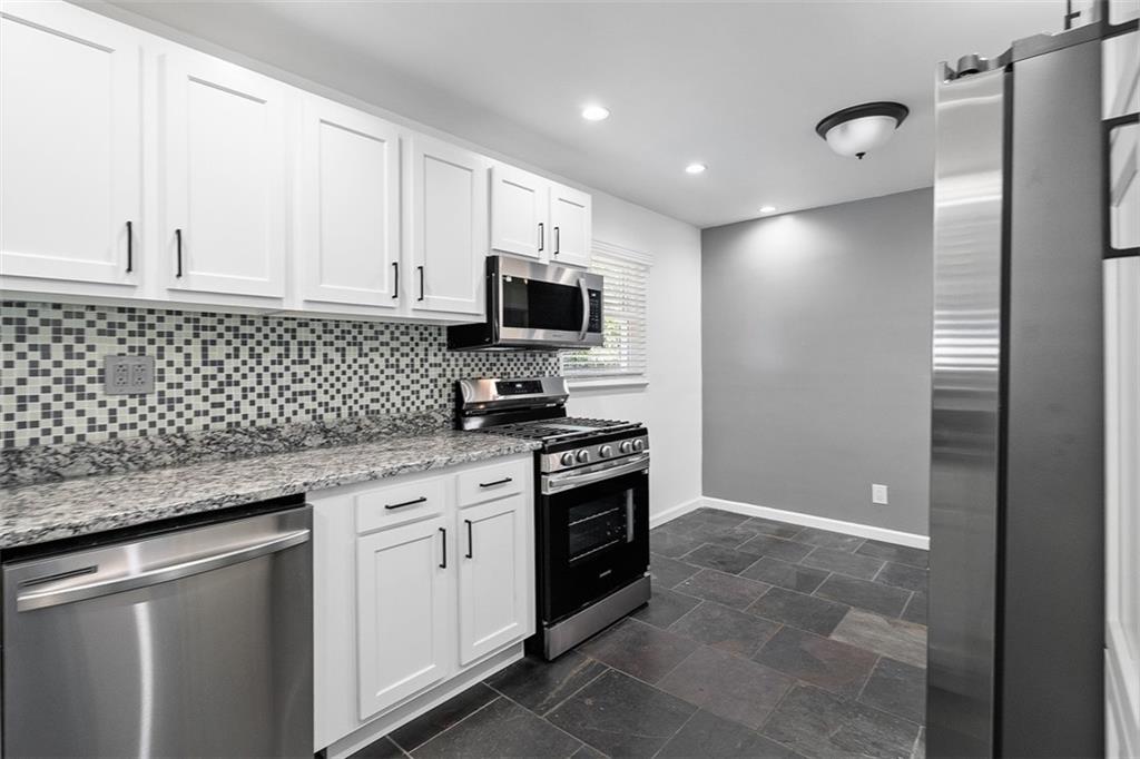 1858 Brodhead Road Aliquippa, PA 15001 - Photo 14 of 27 a kitchen with granite countertop cabinets stainless steel appliances and a counter space