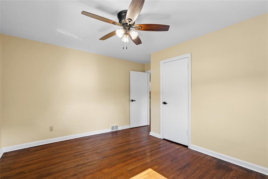 1858 Brodhead Road Aliquippa, PA 15001 - Photo 16 of 27 an empty room with wooden floor and a ceiling fan