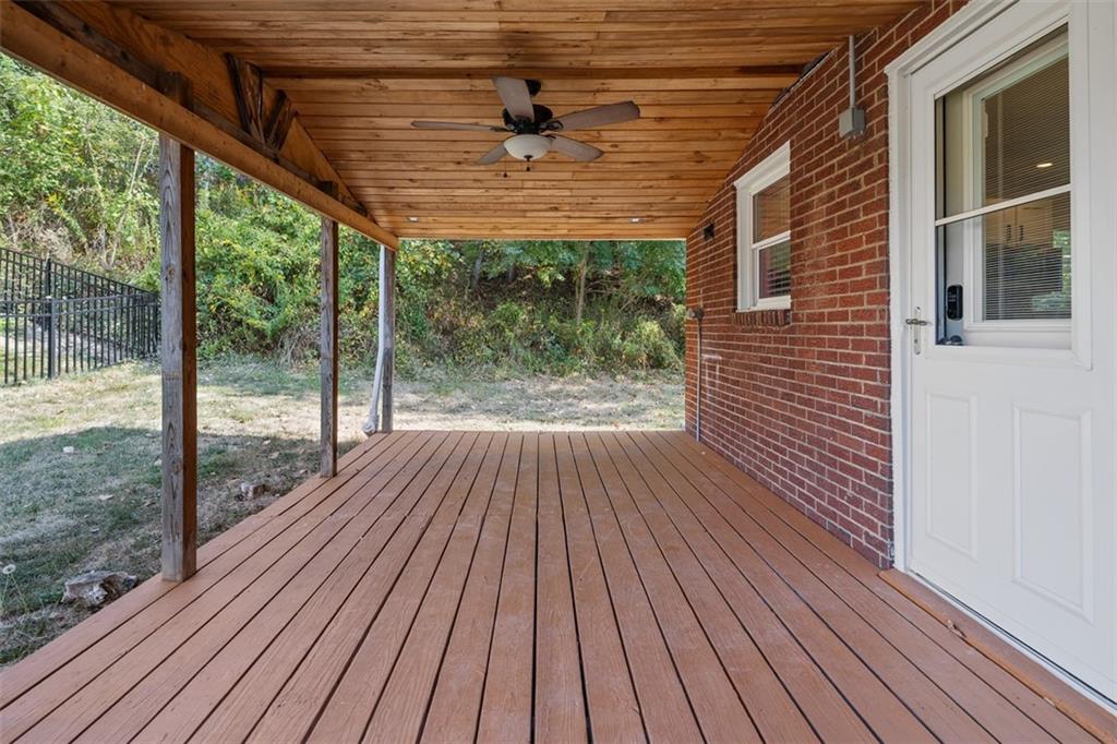 1858 Brodhead Road Aliquippa, PA 15001 - Photo 26 of 27 a porch with wooden floor in front of a house