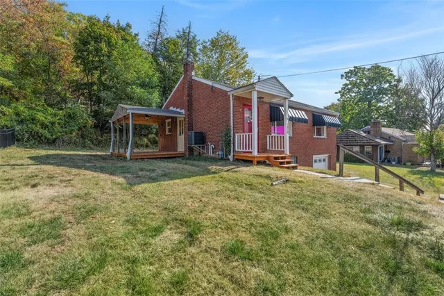 a view of an house with backyard space and balcony