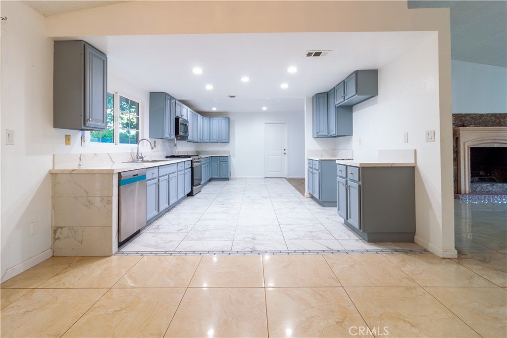 9668 East Ave R 14 Littlerock, CA 93543 - Photo 11 of 34 a large kitchen with stainless steel appliances lots of counter top space