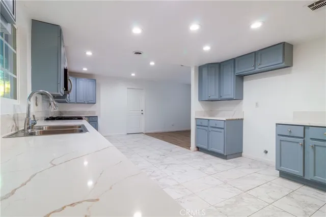 a kitchen with stainless steel appliances granite countertop a sink and cabinets