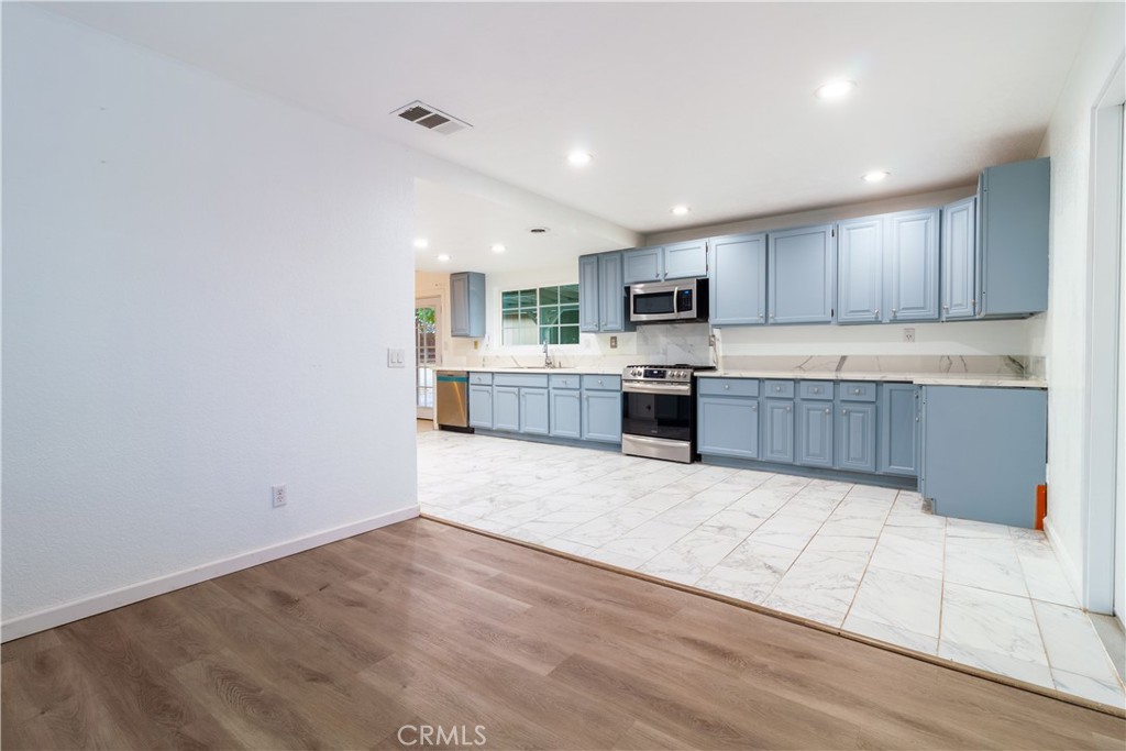 9668 East Ave R 14 Littlerock, CA 93543 - Photo 16 of 34 a large kitchen with cabinets and wooden floor