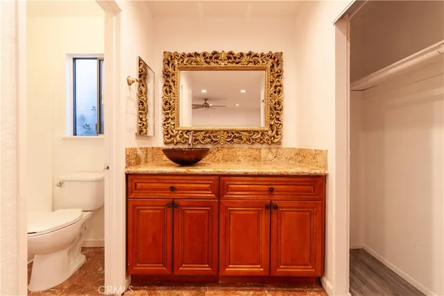 a bathroom with a sink a toilet and mirror