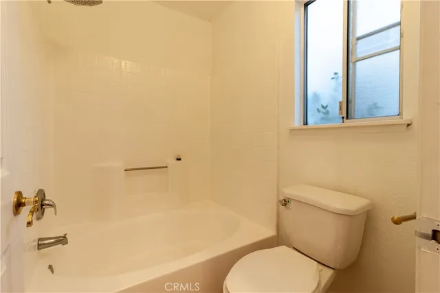 a white toilet sitting next to a bathroom sink