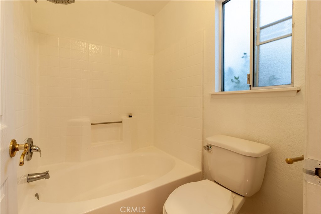 9668 East Ave R 14 Littlerock, CA 93543 - Photo 24 of 34 a white toilet sitting next to a bathroom sink