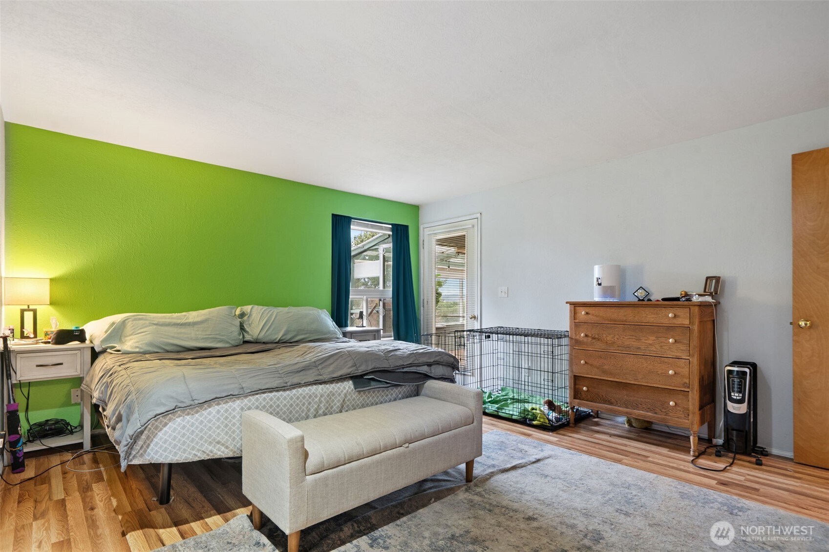 37399 Buck Road Northeast Hansville, WA 98340 - Photo 15 of 40 a bedroom with a bed and a dresser