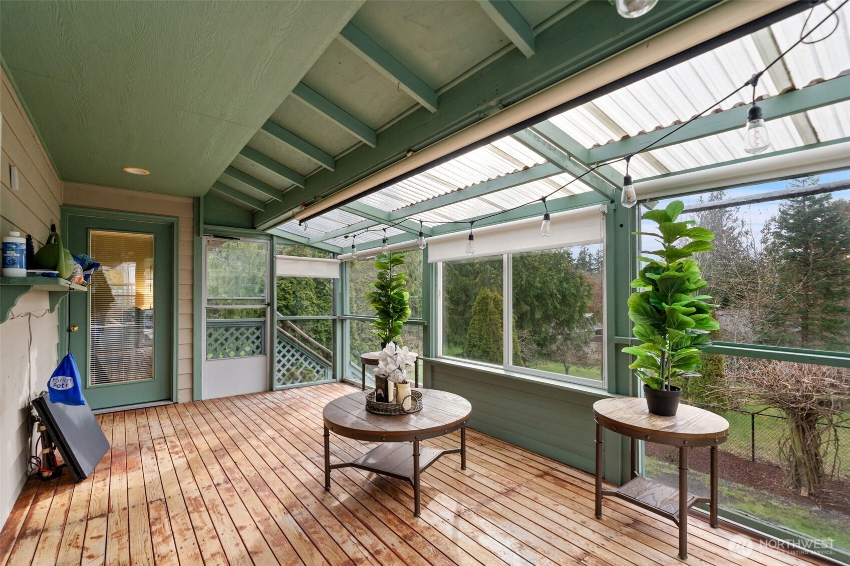 37399 Buck Road Northeast Hansville, WA 98340 - Photo 19 of 40 a view of a porch with furniture and wooden floor