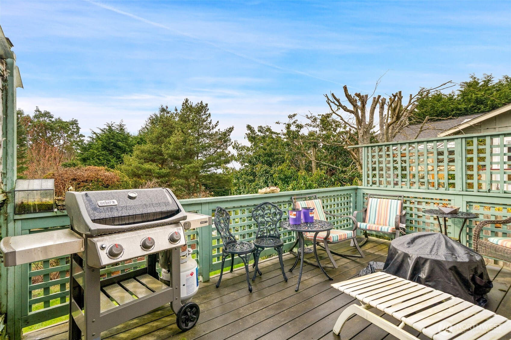37399 Buck Road Northeast Hansville, WA 98340 - Photo 21 of 40 a balcony with wooden floor table and chairs
