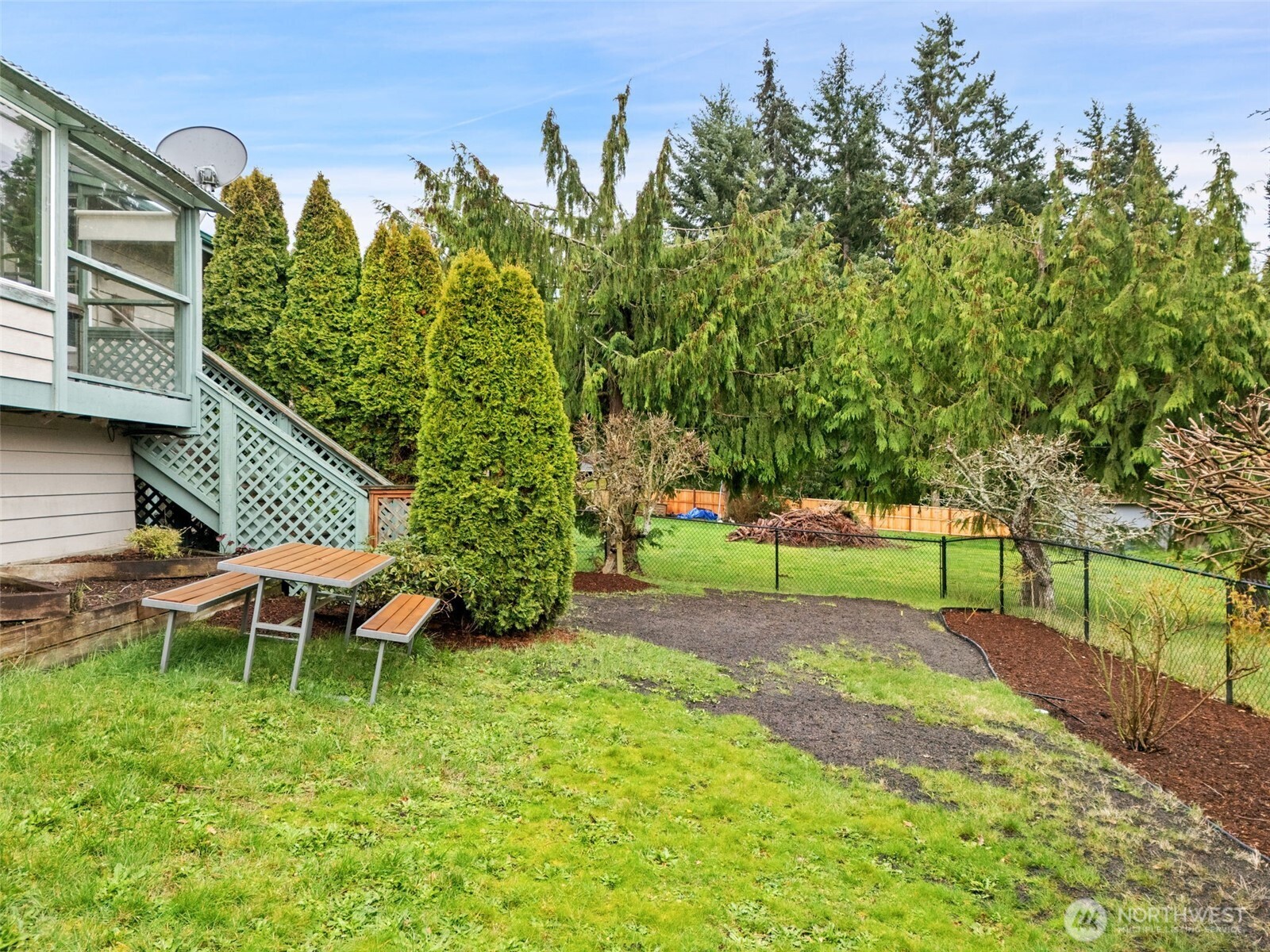 37399 Buck Road Northeast Hansville, WA 98340 - Photo 36 of 40 a view of a backyard with table and chairs and potted plants