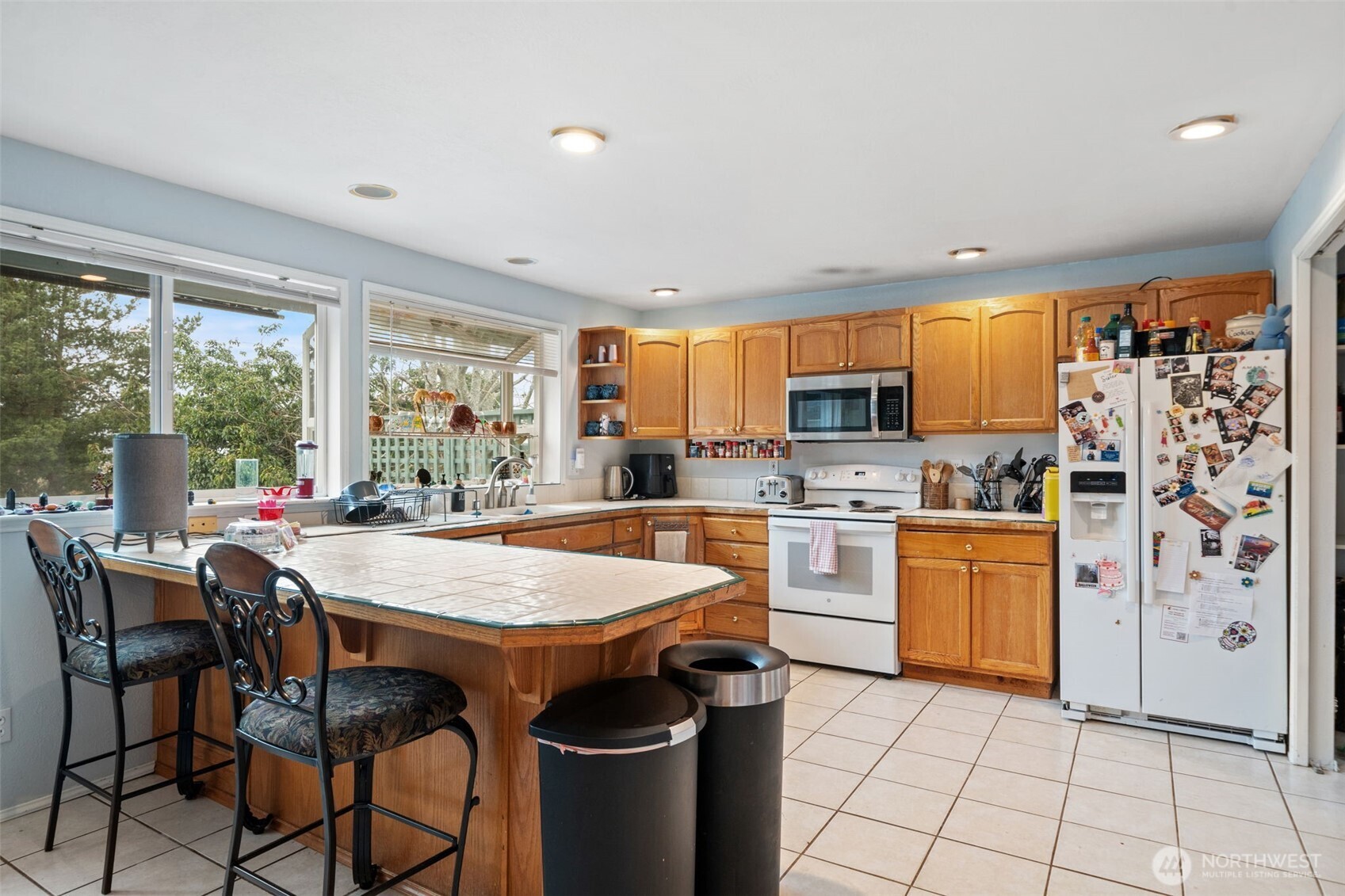 37399 Buck Road Northeast Hansville, WA 98340 - Photo 7 of 40 a kitchen with stainless steel appliances granite countertop a stove top oven a sink dishwasher and a refrigerator with wooden floor