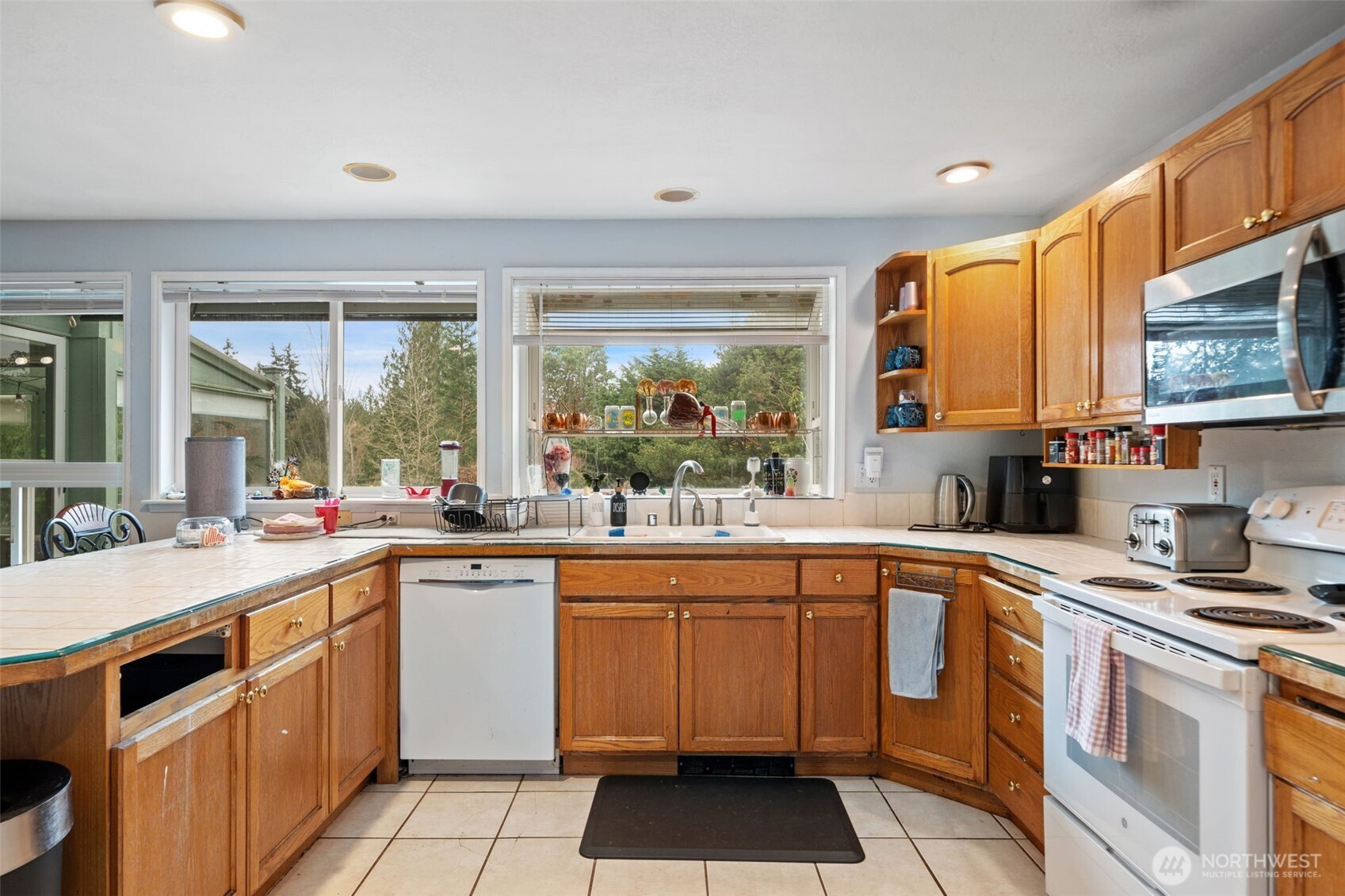 37399 Buck Road Northeast Hansville, WA 98340 - Photo 8 of 40 a kitchen with a sink stove and cabinets
