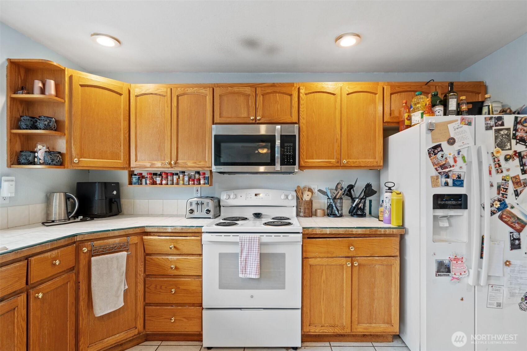 37399 Buck Road Northeast Hansville, WA 98340 - Photo 9 of 40 a kitchen with stainless steel appliances granite countertop a sink stove and refrigerator