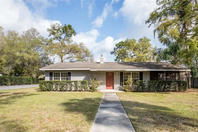 a front view of a house with a yard table and chairs