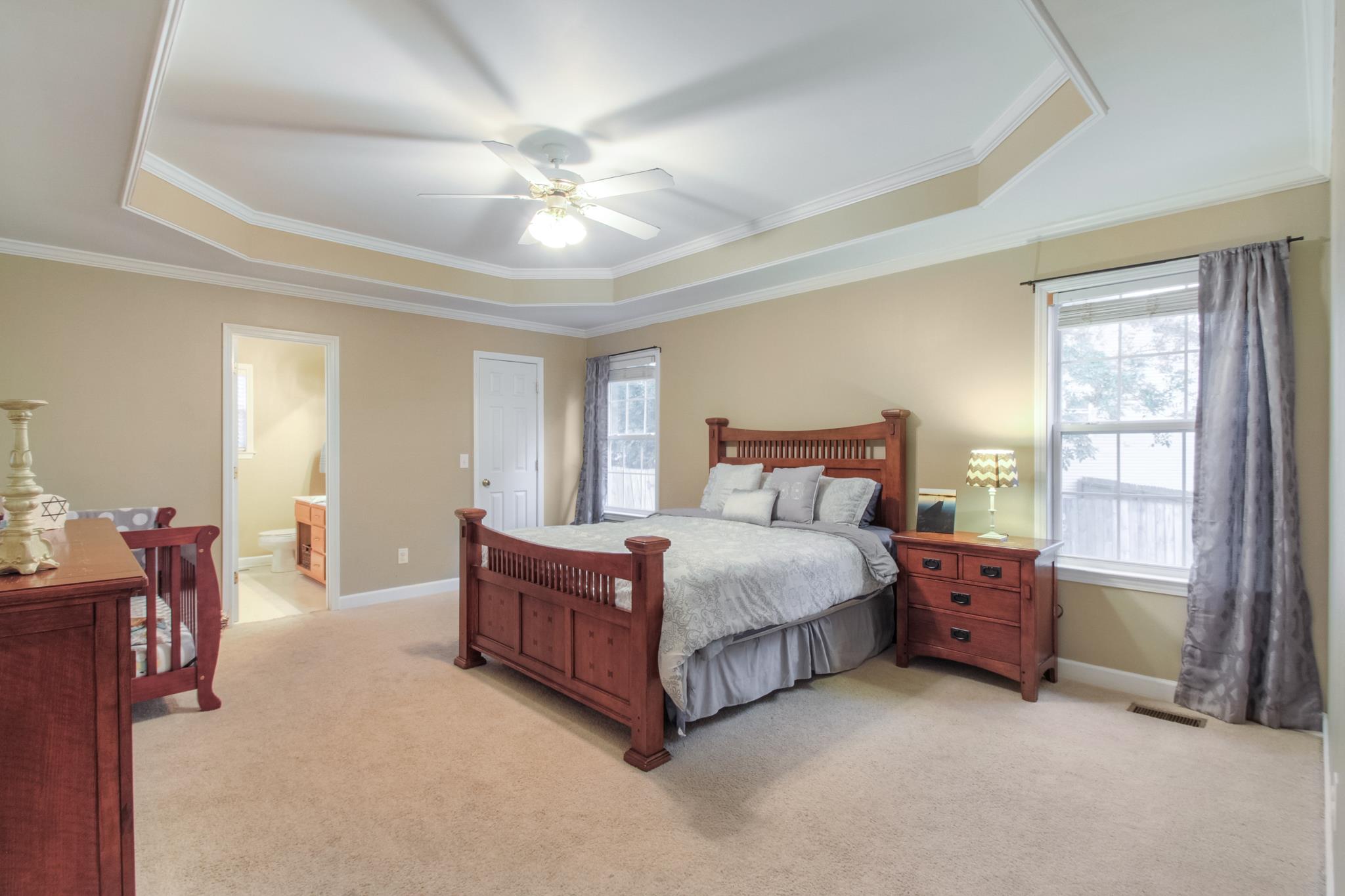 2832 Rippavilla Way Spring Hill, TN 37174 - Photo 8 of 14 a spacious bedroom with a bed and a chandelier